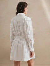 This elegant white shirt dress features a relaxed fit with stylish long balloon sleeves and a cinched waist for a flattering.