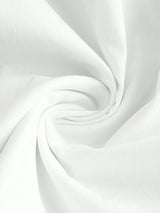 Soft and breathable white fabric spirals gracefully, showcasing its smooth texture and versatility. Perfect for creating.