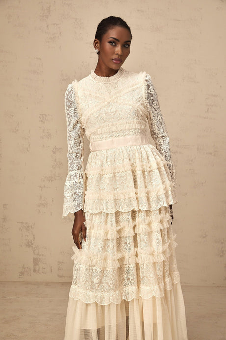 Long flowy maxi dress in neutral tones with lace panels and ruffled tulle details