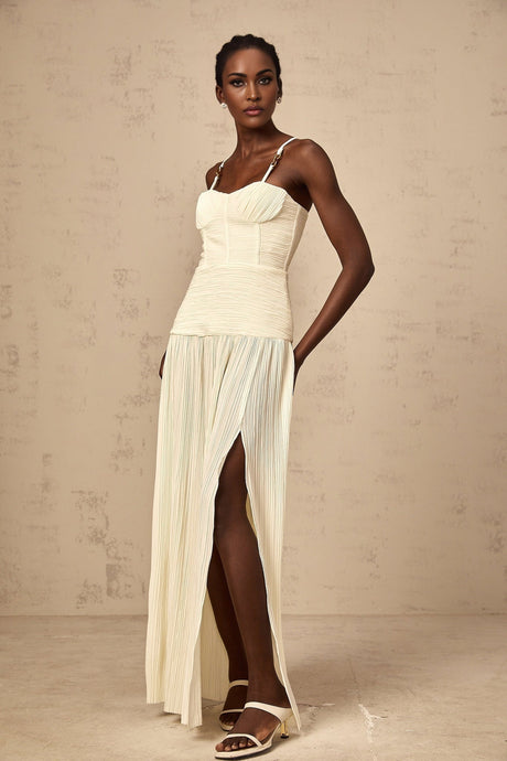 Long neutral colored pleated maxi dress with side slit and Felicie style design