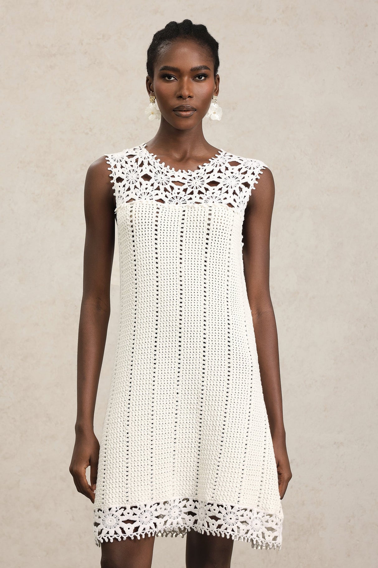 Luigia White Lace Sleeveless Mini Dress with Floral Patterns and Playful Hemline