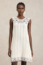 Luigia White Lace Sleeveless Mini Dress with Floral Patterns and Playful Hemline