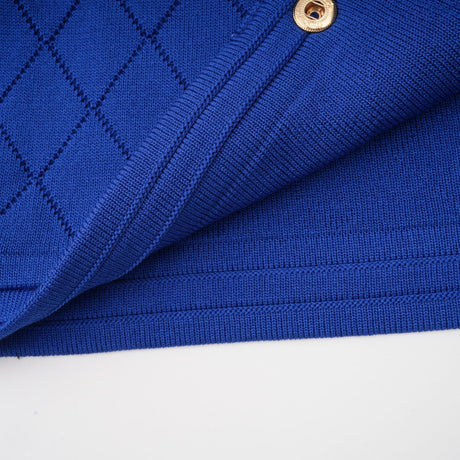 Maelys matching blue knitted set featuring a top with button details and a skirt