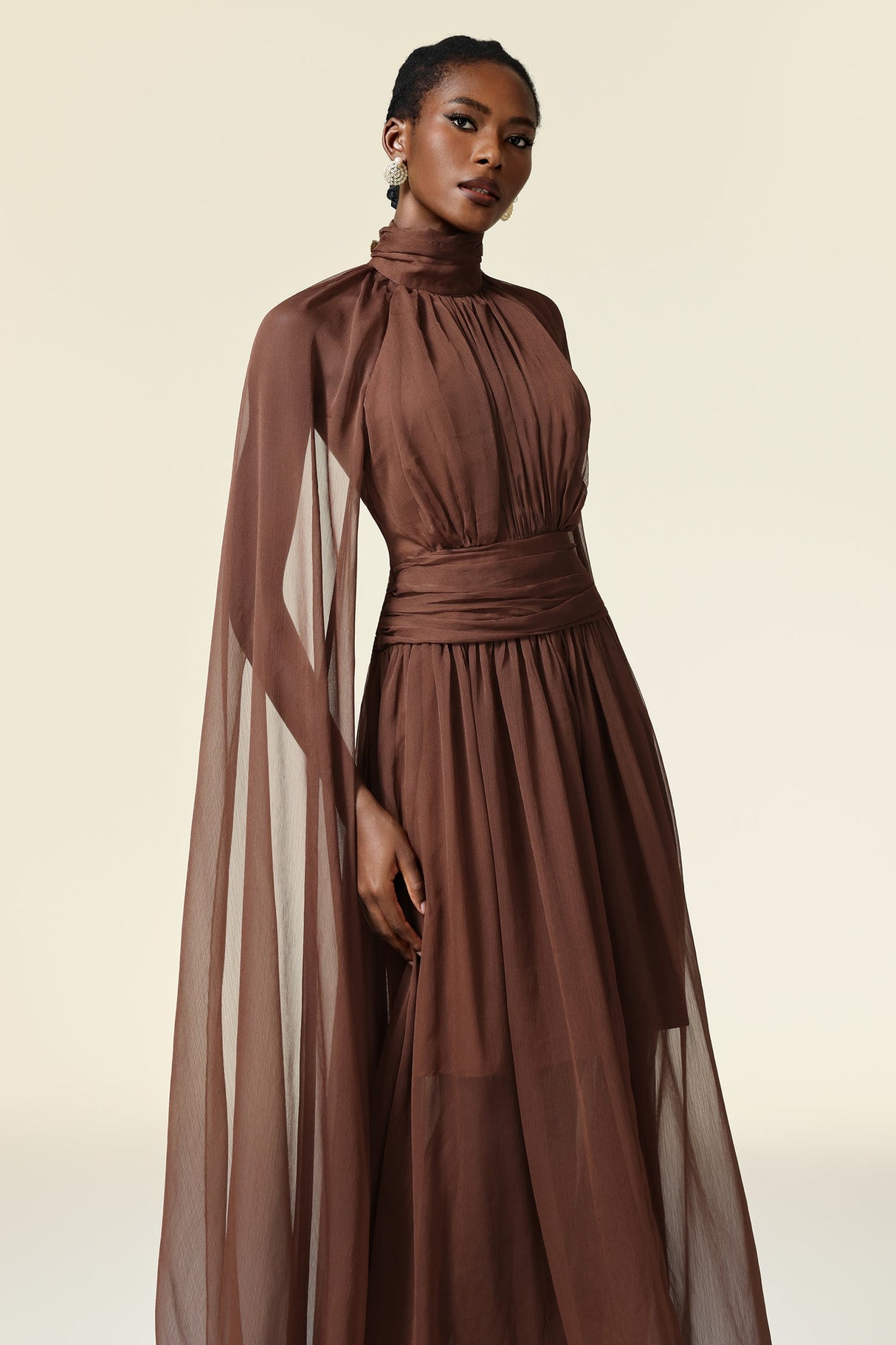 Mariangela Brown Maxi Dress High Neckline Elegant Silhouette Long Sleeves Formal Gatherings Lightweight Breathable Luxurious Texture Flattering Fit Confidence Poise
