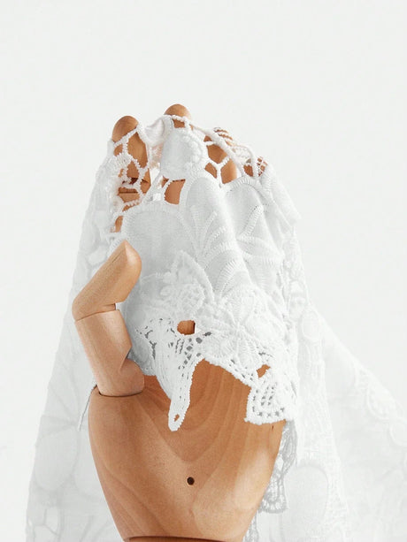 Delicate white lace dress showcasing intricate floral patterns and a romantic, flowing silhouette. Made from lightweight.