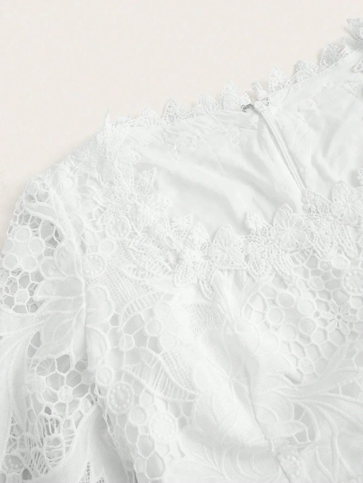 Elevate your wardrobe with this elegant white lace dress featuring intricate floral patterns and a delicate scalloped.