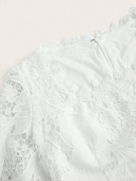Elevate your wardrobe with this elegant white lace dress featuring intricate floral patterns and a delicate scalloped.
