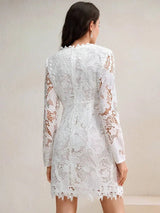 This elegant white lace dress features a fitted silhouette with long sleeves and intricate floral detailing, perfect for a.