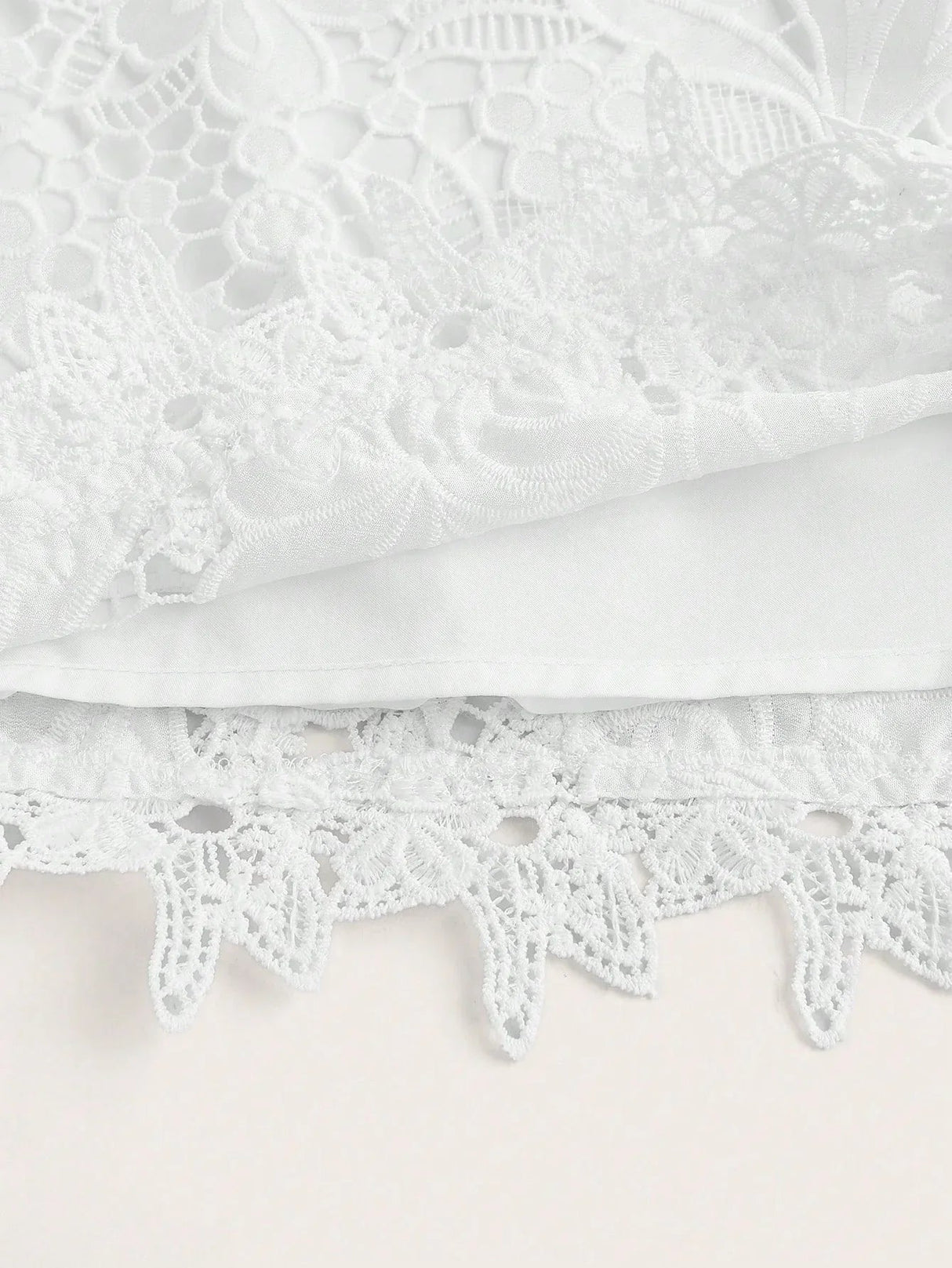 Delicate and enchanting, this white lace dress features intricate floral patterns and a soft, flowing silhouette. Crafted.