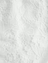 Delicate and elegant, this white lace dress features a beautifully intricate floral pattern that adds a touch of romance..