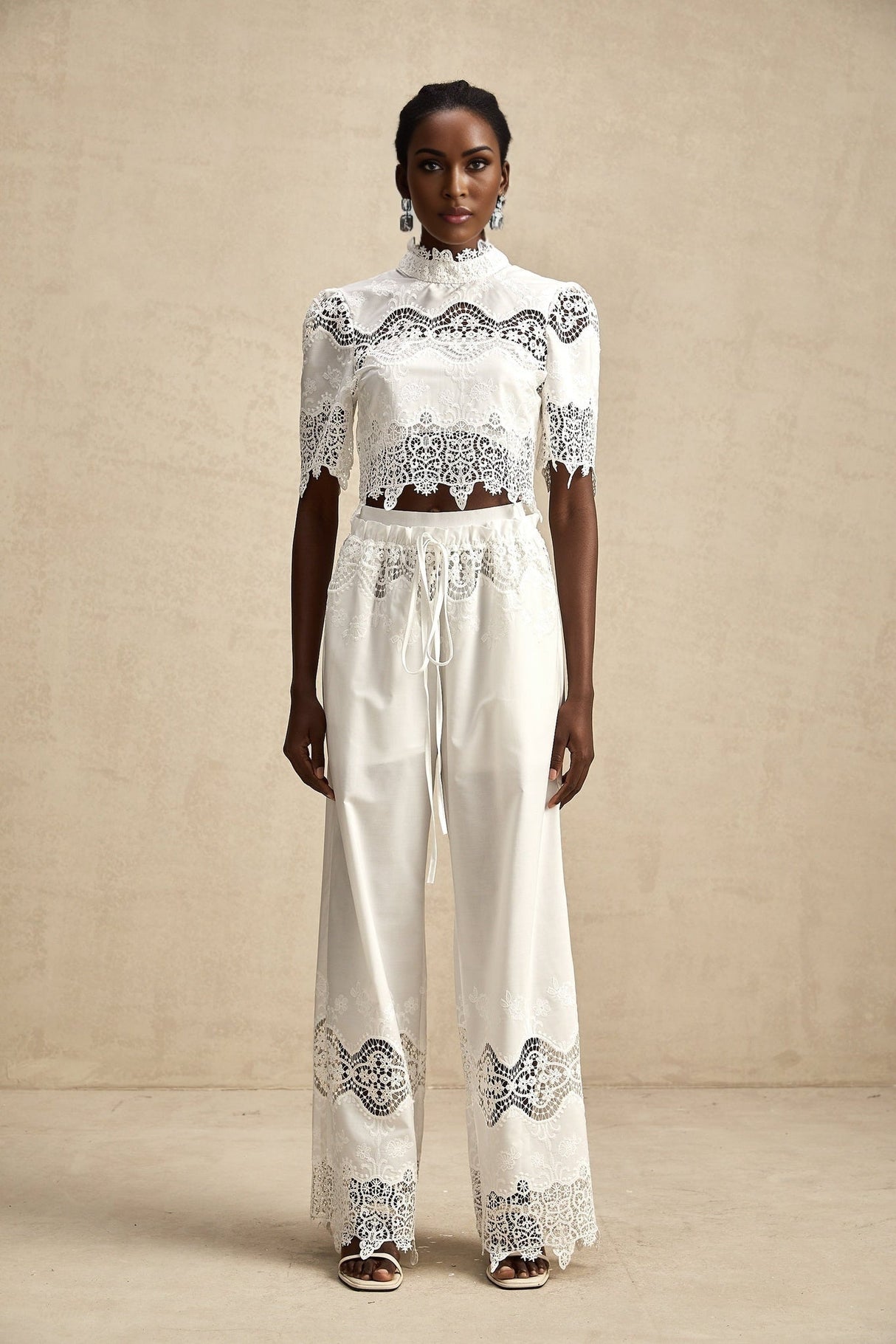 Matching set featuring a cropped top and trousers in white Raphaelle style with lace trim and cutout details