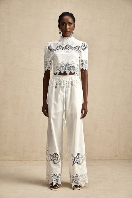 Matching set featuring a cropped top and trousers in white Raphaelle style with lace trim and cutout details