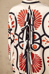 Matching set of Amaranta shirt and trousers with graphic print pattern