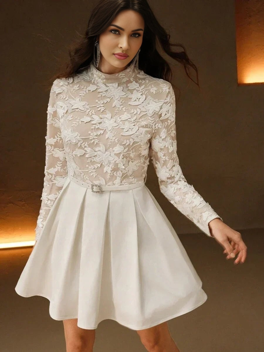 Charming and elegant, this white dress features a fitted bodice adorned with intricate floral lace detailing and long.
