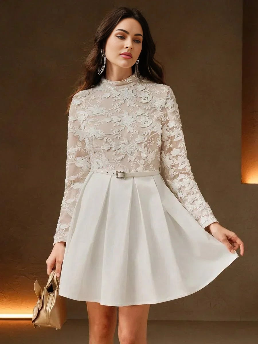 This elegant white dress features a stylishly fitted bodice adorned with intricate floral lace, complemented by long sheer.