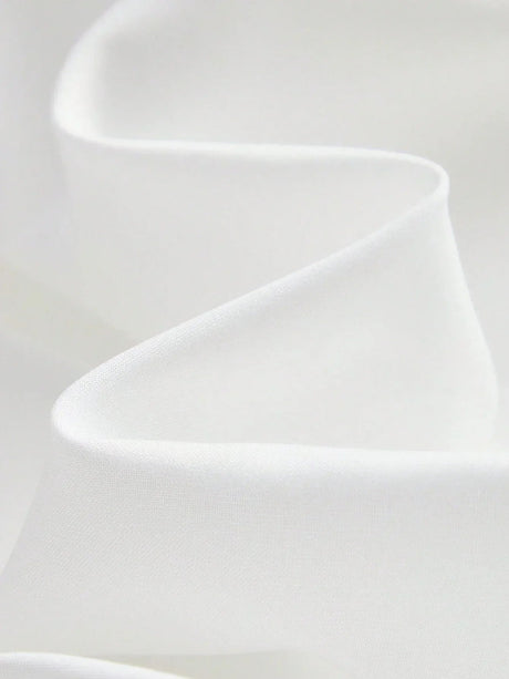 This elegant white dress features a flowing silhouette crafted from soft, lightweight fabric that drapes beautifully. Its.