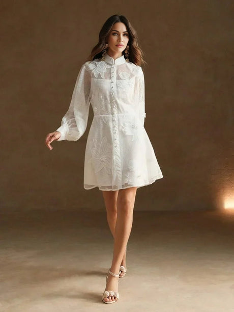 This elegant white dress features delicate floral embroidery and a chic collared neckline, exuding a fresh, feminine vibe..