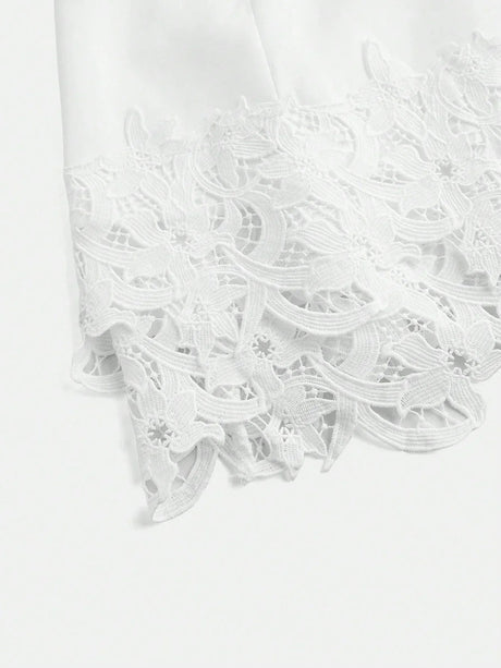 Elegant and ethereal, this white dress features intricate lace detailing at the hem, adding a delicate touch to its classic.