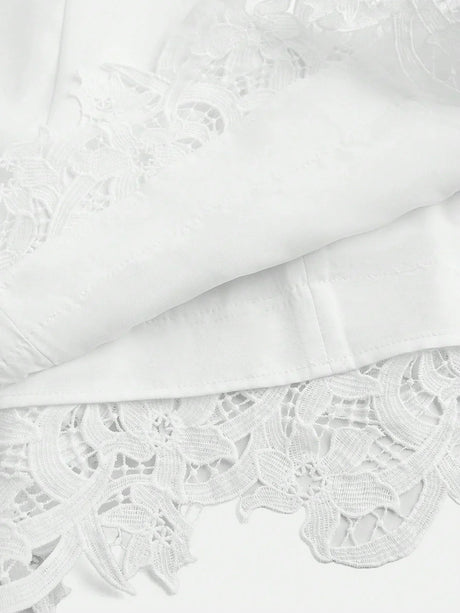 This elegant white dress features intricate floral lace detailing at the hem, adding a touch of sophistication to its.