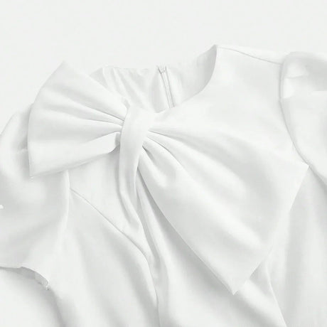 Elegant and ethereal, this white dress features a delicate bow at the neckline, combining sophistication with a touch of.