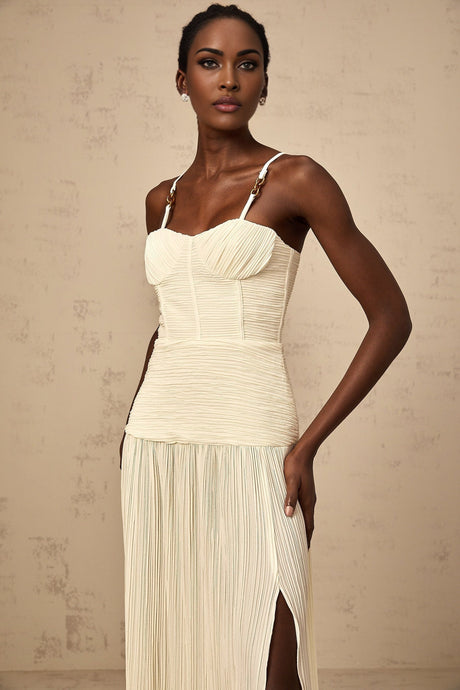 Neutral colored long pleated maxi dress with side slit and Felicie style