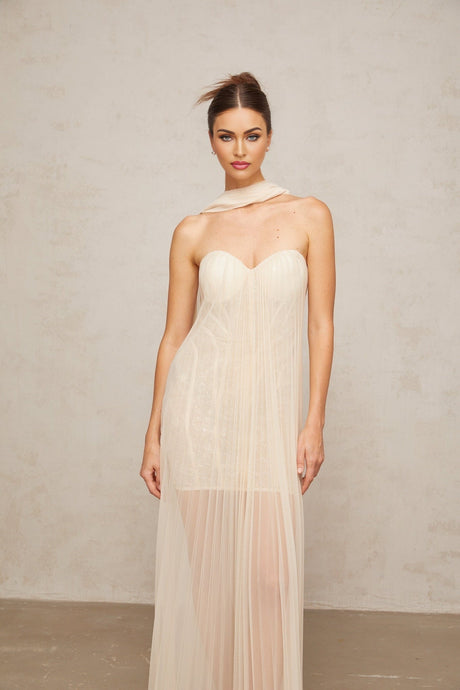 Neutral colored long tulle maxi dress with pleated skirt and ribbon design details