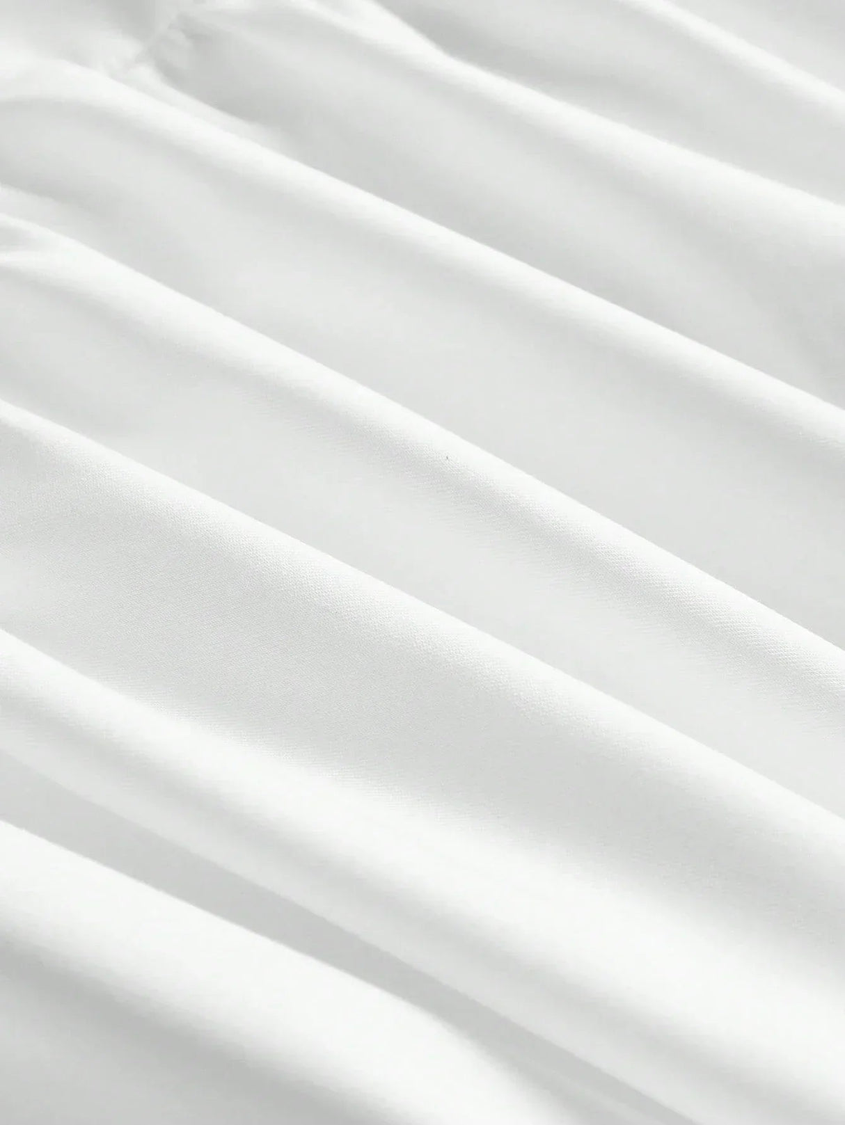 This elegant white dress features a flowing silhouette with soft, delicate pleats that enhance its graceful design. Made.