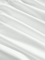 This elegant white dress features a flowing silhouette with soft, delicate pleats that enhance its graceful design. Made.