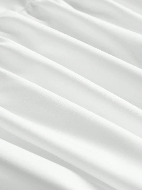 This elegant white dress features a flowing silhouette with soft, delicate pleats that enhance its graceful design. Made.