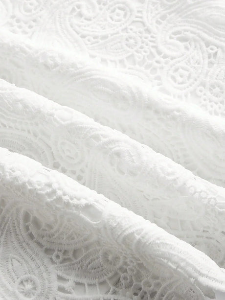 Delicate and elegant, this white lace fabric features intricate patterns that evoke a sense of timeless sophistication. The.