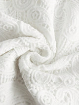 Delicate white lace dress featuring intricate embroidered patterns, exuding elegance and romance. Its soft, lightweight.