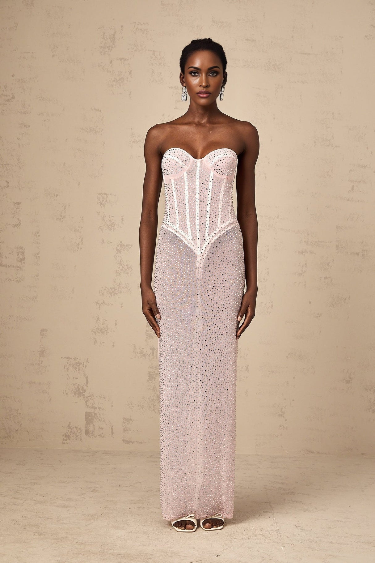 Pink maxi dress with rhinestone embellishments and semi sheer fabric featuring a long flowing design