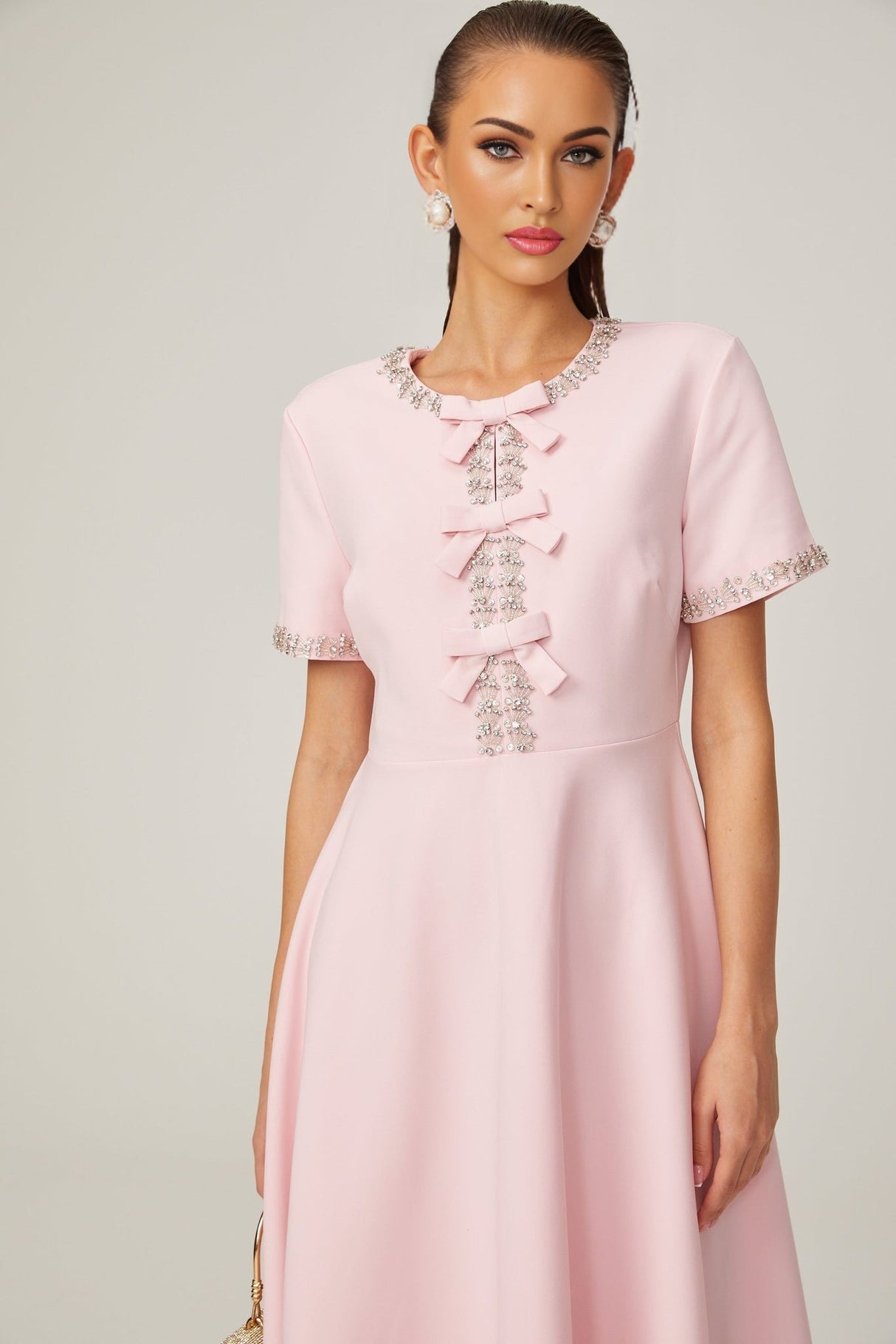 Pink midi dress with crystal accents and bow detail featuring Cassiopeia design
