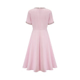 Pink midi dress with crystal accents and bow detail named Cassiopeia