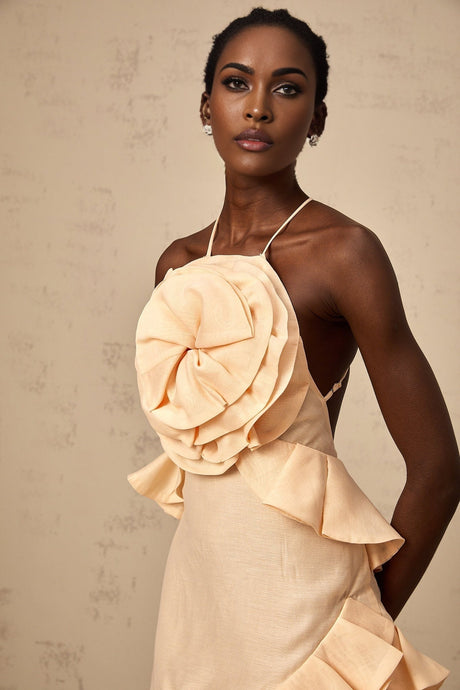 Pink mini dress with 3D petal ruffles and a short hemline featuring a floral inspired design