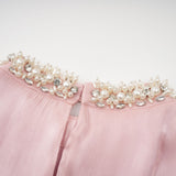 Pink mini dress with pleated skirt and embellished details named Helena