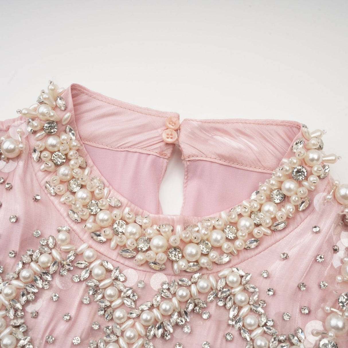 Pink mini dress with pleated skirt and embellished details named Helena
