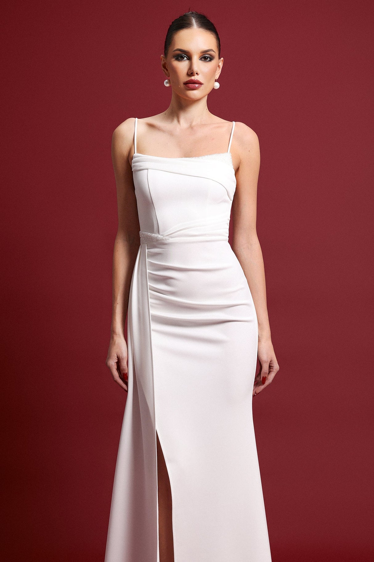 Raegan White Maxi Dress Sleek Silhouette Sophisticated Neckline Pleated Detailing Side Slit Fit Feel Elegant Contemporary Style Formal Evening Events Wedding Gala High Quality Materials Turn Heads Lasting Impression