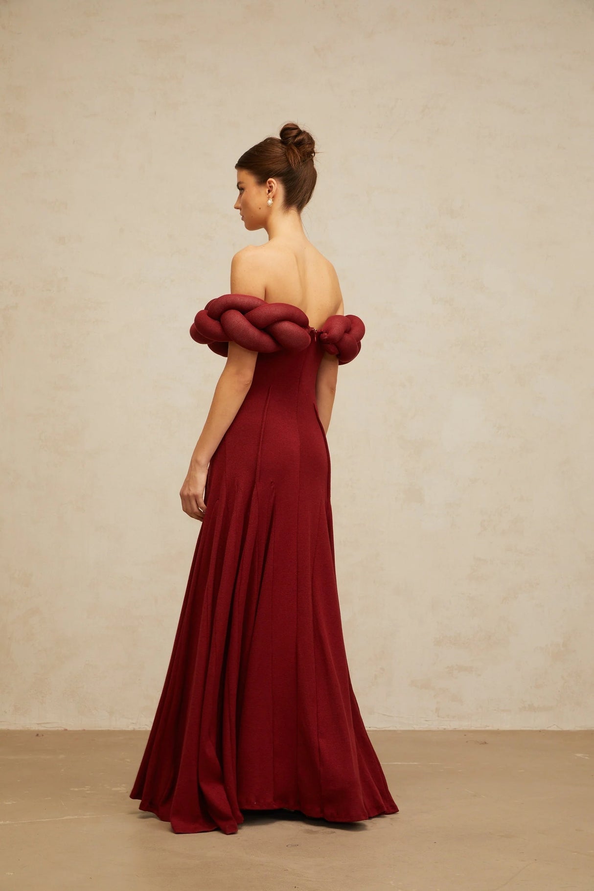 Red knit maxi dress with braided design details by Roxane