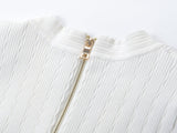 Roselia Top – Fitted Ribbed Knit – Short Sleeves – Gold Button Detail – Front Pockets – Tailored Silhouette – Textured Fabric
