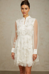 Short white mini dress with 3D floral tulle petals covering the bodice and skirt