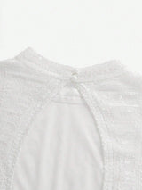 This elegant white dress features a delicate, sequined bodice that shimmers softly in the light, complemented by a smooth.