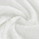 This elegant white dress showcases a shimmering sequined fabric that catches the light beautifully, creating a stunning.