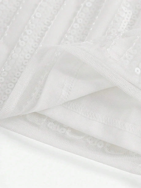 This elegant white dress features shimmering sequins and a flowing design that exudes sophistication. The lightweight fabric.