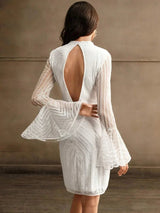 This elegant white dress features a striking open back and flowing bell sleeves, creating a chic silhouette perfect for.