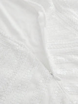 This elegant white dress features a shimmering sequin design that catches the light beautifully, offering a glamorous touch.