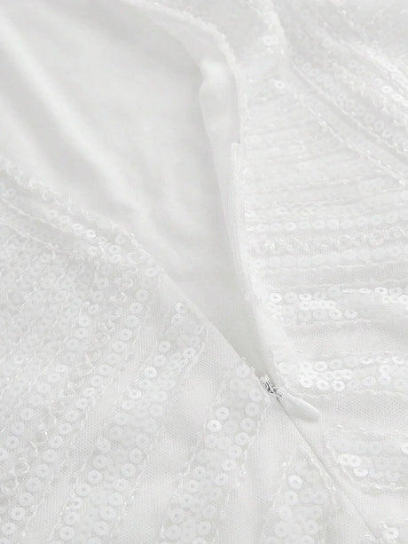 This elegant white dress features a shimmering sequin design that catches the light beautifully, offering a glamorous touch.
