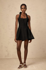 Sleek black halterneck mini dress with bow detail at neckline