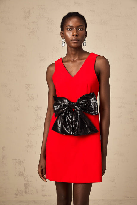 Sleeveless red mini dress with v neckline and sequin bow detail