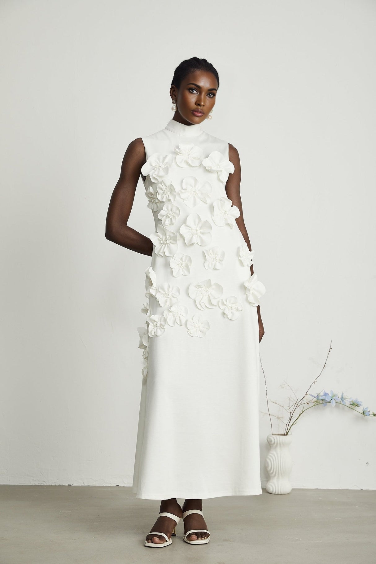 Sleeveless white maxi dress with bow and decorative artificial flowers named Magali
